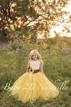 Sunflower Dress Yellow Dress Flower Girl Dress Shabby Chic Lace Dress Tulle dress Wedding Dress Birthday Dress Toddler Dress sunflower Girls Dress Imagine your little princess twirling and dancing in this ultra fluffy tulle tutu at your wedding!  This set includes a top and skirt with a brown satin sash and sunflower clip.    Please measure your length from waist to floor (it is for skirt length).  We will also need either child's age or a measurement for top length from collarbone to her hip bone.  It is important that you measure past her waist as the top in made longer to go under the skirt so the tummy does not hang out. Our top has a lace up back to ensure a proper fit.  Top is pictured in white lace over sunflower yellow fabric.  Other colors are available upon special order...  Just Sunflower Flower Girl Dress, Yellow Sunflower Dress, Yellow Tulle Dress, Toddler Tutu Dress, Yellow Flower Girl Dresses, Girls Yellow Dress, Toddler Birthday Dress, Gold Lace Dresses, Hip Bone