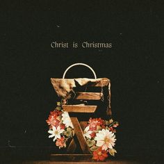 a chair with flowers around it and the words christ is christmas