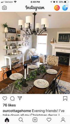 the dining room is decorated for christmas with white plates and greenery on the table