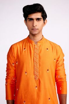 Orange short kurta with mirror, beads, thread,  and sequin embroidered motifs all-over. Comes with plain orange pant. - Aza Fashions Festive Kurta With Mirror Work In Slub Silk, Festive Slub Silk Kurta With Mirror Work, Orange Kurta With Mirror Work For Eid, Traditional Orange Kurta With Mirror Work, Dola Silk Kurta With Resham Embroidery For Puja, Orange Bollywood Kurta With Mirror Work, Bollywood Style Orange Kurta With Mirror Work, Eid Puja Dola Silk Kurta, Eid Kurta With Multicolor Embroidery And Mirror Work