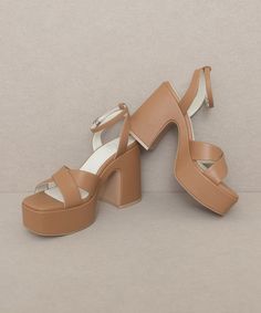 This gorgeous chunky sandal is bringing all the 70's glam. The Norah features a cross strap front and a sweet ankle buckle detail.Heel Height: 4.25"The front platform: 1.5"Types of closures: Slip on/ BuckleClog, Retro, Vintage Chic Chunky Platform Sandals With Open Heel, Block Heel Wedge Sandals With Buckle Closure For Party, Party Wedge Sandals With Block Heel And Buckle Closure, Brown Chunky Platform Sandals For Party, Party Wedge Sandals With Block Heel In Medium Width, Party Wedge Sandals With Block Heel Medium Width, Party Wedge Sandals With Block Heel And Medium Width, Chic Brown Chunky Platform Heels, Brown Block Heel Wedge Sandals For Party