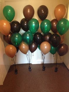 a bunch of balloons that are sitting on the ground in front of a wall and door