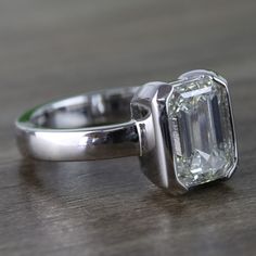 a diamond ring sitting on top of a wooden table