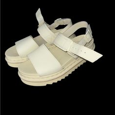 These Are Dr. Martens Voss Sandals In A Creamy White/ Pale Yellow Color. They Feature A Chunky Platform Sole With The Brand's Signature Yellow Welt Stitching And A Ripple Tread. The Sandals Have A Smooth Leather Upper With Two Adjustable Straps, One Across The Toe And Another Around The Ankle, Secured With Metal Buckles. Dr Martens Voss Sandals, Voss Sandals, Dr Martens Voss, Cream Sandals, Yellow Cream, Chunky Platform, Pale Yellow, Creamy White, Metal Buckles