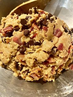 a metal bowl filled with cookies and chocolate chips