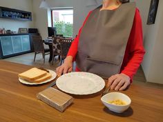 a woman standing in front of a table with food on it