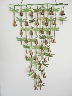 a metal wind chime hanging from a wall