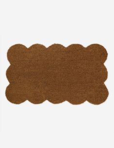 a brown rug with scalloped edges on a white background