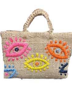 a handbag with an eye on the front and colorful flowers on the side,