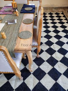 a dining room table and chairs with place mats on the floor in front of it