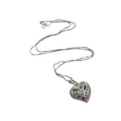 This vintage silver heart locket necklace is a timeless piece that carries both elegance and sentiment. The delicate chain adds a touch of sophistication, while the heart-shaped locket invites you to store cherished memories close to your heart. An ideal accessory for those who appreciate classic beauty and emotional connections. * Heart-shaped locket * Intricate design * Delicate chain * Silver material * Vintage style Minor tarnish and patina consistent with vintage age. Size: Womens 18" Condition: Pre-Owned Good Silver Heart Locket, Heart Locket Necklace, Chain Silver, Delicate Chain, Heart Locket, Silver Material, Cherished Memories, Classic Beauty, Intricate Design