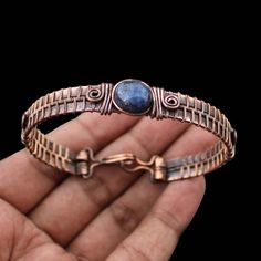 Lapis Lazuli Cuff Bracelet Copper Wire Wrapped Bangle Cuff Adjustable Bangle Gemstone Bracelet Handmade Bangle Copper Bangle Lapis Jewelry Main Stone - Lapis Lazuli Bangle Length - 2.50 - 2.75" Inches (Adjustable) Bangle Width  -  0.50 Inches Metal                  -  Copper Copper Has Been Used For Jewelry Making For Thousands Of Years, Dating Back To Ancient Civilisations Such As The Egyptians, Romans, And Aztecs. Copper Was Valued For Its Beauty, Versatility, And Durability, And Was Often Use Adjustable Artisan Metal Bangle, Artisan Metal Cuff Bangle Bracelet, Handmade Artisan Metal Bangle, Handmade Metal Artisan Bangle, Artisan Wire Wrapped Adjustable Bracelets, Adjustable Artisan Bangle Cuff Bracelet, Handmade Adjustable Metal Bracelets, Spiritual Wire Wrapped Cuff Bangle Bracelet, Spiritual Wire-wrapped Bangle Cuff Bracelet