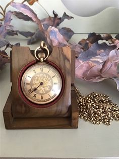 This Ladies pocket watch has been crafted in rich 18ct gold.   Made by William Gadsby of Lincoln, a clock and watchmaker active during the period 1856 - 1900 it has his stamp on the inside cover. Our research suggests this watch was made around 1871. It is a stem-wind open face pocket watch with a gold floral centre, Roman numerals and blued hands. (There is some slight rubbing on the last few Roman numerals) The outer case has beautiful etchings around the edges and the back has been intricatel Antique Pocket Watch, Mechanical Pocket Watch, Watch Stand, Pocket Watch Antique, Watch Display, After All These Years, Dog Clip, Pocket Watch Chain, Open Face