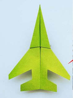 an origami airplane made out of green paper