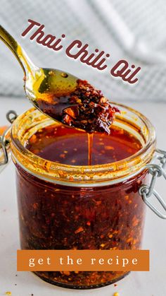 a spoon full of chili sauce on top of a table with the words, get there recipe