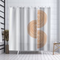 a bathroom with a shower curtain that has an image of the letter s on it