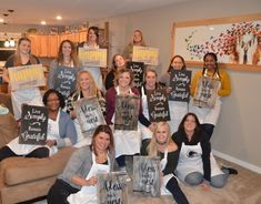 a group of women holding up signs in the living room