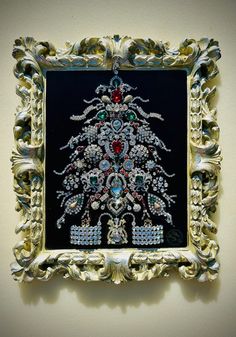 an ornate gold frame with a beaded christmas tree on it