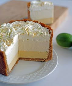 two slices of cheesecake on a plate with limes