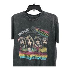 the pink floyd tour t - shirt hanging on a hanger in front of a white background