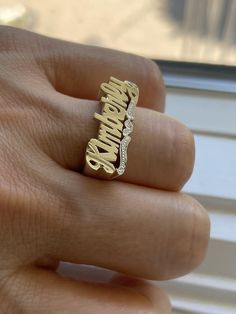 Medium Size Personalized Name Ring In Real 10K & 14K Gold *FLAT FACE * MADE IN USA (HAND MADE ITEM) Make the names of your family, friends and love ones into rings for their gift. It's great as an everyday necklace and makes an awesome gift! This Item is 100% customization especially for you. Item Description *Material: Real Gold *Type: *FLAT FACE* ( Like photo) with Heart Tail with Bit Work *Ring size: ring sizes between 1-11 (including half sizes) *Size of Ring : 20mm*8mm *Script Design *O Script Design, Flat Face, Name Ring, Like Photo, Name Rings, Gold Flats, Birthday List, Everyday Necklace, Name Jewelry