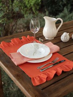 a place setting on a wooden table outside