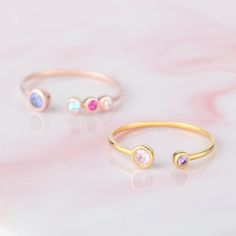 "♥ Custom Birthstone Ring ♥ Customed by kids' birthstones, this beautiful and dainty ring is a perfect gift for your mom or your loved one. P R O D U C T ∙ I N F O * Material: Solid 925 Sterling Silver * Finishing: Silver - Yellow Gold - Rose Gold * Up to 1 big stone, 5 small stones * Big stone measures approx. 1/8'' (3mm) , Small stones measure approx. 1/16'' (2mm) H O W * T O * O R D E R 1. Select the drop-down option you want 2. Please let us know the following information in the \"Add your p Adjustable Stackable Rings For Birthday, Mother's Day Open Birthstone Ring Gift, Adjustable Stackable Birthstone Ring For Mother's Day, Stackable Birthstone Ring For Mother's Day, Mother's Day Stackable Birthstone Ring, Dainty Adjustable Birthstone Ring With Accent Stones, Open Ring Birthstone With Bezel Setting For Gift, Open Birthstone Ring With Bezel Setting As Gift, Pink Birthstone Ring For Birthday