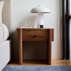 a table with a lamp on it next to a couch