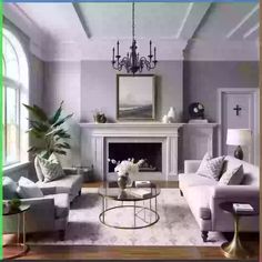 a living room filled with furniture and a fire place under a chandelier in front of a fireplace