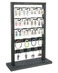 a display rack with earrings and bracelets on it