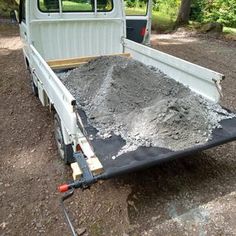 there is a truck that has some dirt in the bed