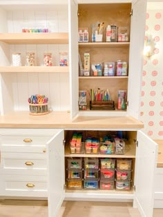 an organized pantry with lots of crafting supplies in the cupboards and shelves on the wall