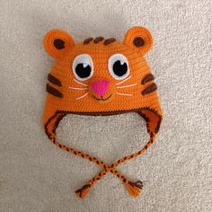 a crocheted hat with a tiger face on it