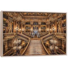 the grand staircase in an old building with chandeliers on either side and lights hanging from the ceiling