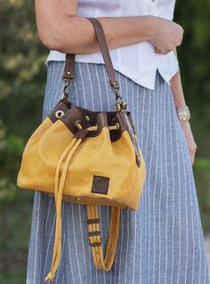 Yellow-brown genuine leather drawstring bag for women. 100% handmade by traditional sewing method. Each stitch is handcrafted for a durable and beautiful finish. The bag has two straps - one adjustable and long for carrying on the shoulder or over the shoulder, the other for carrying the bag in the hand or on the wrist. Both straps can be detached from the bag. The interior of the bag is lined with high quality fabric.  Very handy bag for every day and party. The author's model of high quality, only one bag is available. Ready to ship within 1-3 business days. Here you can see more of my bags. https://www.etsy.com/il-en/shop/MBbags?ref=search_shop_redirect Inside the bag: + 1 pocket + 1 zip pocket  FUNCTIONS: + handmade in Israel + bucket bag EXTERIOR DIMENSIONS: + W: 23 cm / 9 inches + H: Leather Drawstring Bags, Leather Bag Women, Leather Bucket Bag, Leather Bucket, Genuine Leather Bags, One Bag, Bag Women, Fun Bags, Leather Crossbody Bag