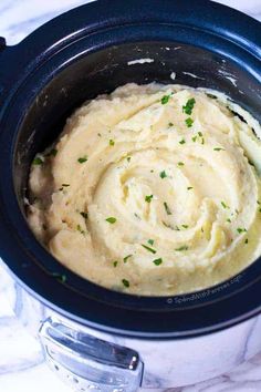 mashed potatoes in a slow cooker with parsley