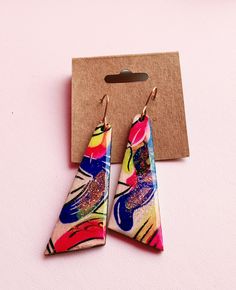 These earrings are sure to get attention, they are one of a kind and hand painted! They are bright and colorful making them easy to find something to match them! They are light weight despite their size, they have a wooden base and are sealed to last with high quality UV resin! They are also made using 14kt gold filled ear wires to ensure they are kind to even sensitive ears! All earrings come with their own jewelry polishing cloth!Each order is ships with USPS and a tracking # 💜 CARE INSTRUCTIONS 💜 Resin can be cleaned with soap and water. Your jewelry should be stored in an airtight bag or jewelry box that is in a cool, dry environment to protect from oxidation 💌 Please contact me with any questions.💌 ❣️ I do my best to ensure a quick and timely response! ❣️ Colorful Hand-painted Drop Earrings, Colorful Hand Painted Drop Earrings, Colorful Hand Painted Earrings As Gift, Colorful Hand Painted Earrings For Gift, Hand Painted Colorful Earrings For Gifts, Multicolor Hand Painted Fun Earrings, Fun Multicolor Hand Painted Earrings, Fun Hand-painted Pink Earrings, Fun Hand Painted Pink Earrings