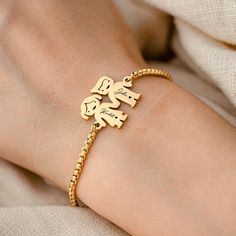 Celebrate the joy of childhood with our Personalized Charm Engraved Gold Plated Bracelet. This delightful piece captures the innocence and wonder of youth with its whimsical girl and boy silhouette charms. Crafted with care, this bracelet is made from 18K gold plated stainless steel, ensuring it is durable, waterproof, and hypoallergenic. It's a lasting treasure designed to withstand the active, playful days of childhood. Each charm, measuring 23.5mm x 20mm, can be personalized with a special da Name Charm Bracelet For Friendship, Boy Silhouette, Simple Bracelets, Gold Plated Bracelets, Playful Design, Meaningful Gifts, 18k Gold, Initials, Gold Plate