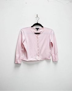 "a vintage tommy hilfiger light pink cropped cardigan with pearlescent buttons and cropped sleeves ✿ IMPORTANT INFORMATION: * ok vintage condition - marks pictured (price reduced) * size: extra-small - please check exact measurements below (they're there for your benefit!) * garment care: machine washable ✿ MEASUREMENTS (taken while item is lying flat, some measurements will need to be doubled): * shoulder to shoulder: 15.5\" (39cm) * armpit to armpit: 16.5\" (42cm) * length (centre of back neck Pink Knit Cardigan, Tommy Hilfiger Cardigan, Cropped Sleeves, Cardigan Vintage, Crop Cardigan, Vintage Crop Tops, Cardigan Crop, Vintage Ralph Lauren, Pink Knit