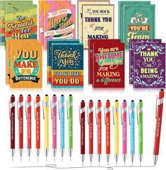 many different colored pens and greeting cards