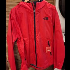 Get Ready To Take On The Great Outdoors With This Stylish And Functional Windbreaker Jacket From The North Face. Crafted From High-Quality Nylon, This Jacket Is Built To Withstand The Elements And Keep You Looking Your Best. The Solid Pattern In A Bold Red Color Adds A Pop Of Style To Your Outfit, While The Zip Closure And Accents Provide A Secure And Comfortable Fit. Red Windproof Outerwear For Fall, Red Hooded Windproof Outerwear, Fall Windproof Red Outerwear, Red Hooded Outerwear For Outdoor, Red Windbreaker With Detachable Hood For Fall, Fall Red Windbreaker With Detachable Hood, Functional Red Hooded Jacket For Outdoor Activities, Functional Red Outerwear With Drawstring Hood, Red Functional Outerwear With Drawstring Hood