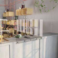 a kitchen counter with several shelves and bottles on it