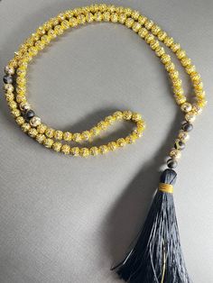 Gorgeous 8mm full tasbeeh- 99 beads with spacers between 33 beads.  This is a made out of high quality 18k gold plated beads and black agate accent stones Weight: 53 grams Length: 52 cm 30% of proceeds go to charity Shipping: Canada: Free Expedited shipping- 2-8 business days USA: Free Shipping- 6-12 business days Everywhere Else: 3 weeks Gold Mala With 8mm Beads For Meditation, Adjustable Gold Mala With 8mm Beads, Gold 108 Beads Mala For Meditation, Gold Mala With 108 Beads For Meditation, Gold Rosary With 8mm Beads For Meditation, Gold Rosary For Meditation, Gold Spiritual Rosary For Meditation, Gold Mala With 108 Beads As Gift, Adjustable Gold Mala With Round Beads