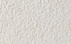 white stucco textured wall with small holes in the middle