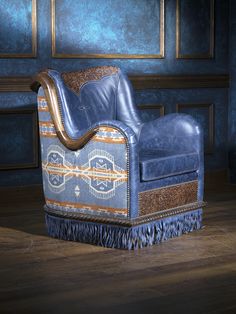 a blue leather chair sitting on top of a hard wood floor next to a wall