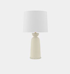 a white table lamp with a white shade on the base and a light bulb attached to it