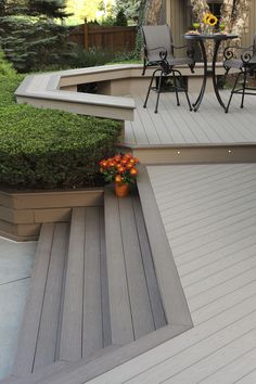 an outdoor patio with steps leading to a table and chairs