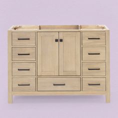 a wooden cabinet with drawers and doors on the bottom shelf, against a purple wall