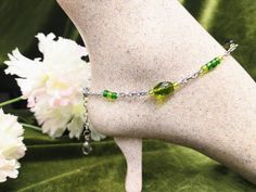 "Green Beaded Anklet & Bracelet 💚 \"One-Size-Fits-Most\" ankle bracelet, that can also be worn as a wrist bracelet! Two in One! : Made with sturdy all stainless steel metals. : Beads:  Green oval faceted glass beads, and light and dark green glass seed beads bring life to this bracelet. : As an Anklet: Fits 9 1/2 to 11 1/2 inch ankles. Attach the first clasp to the loop or wherever it fits you best along the chain.  (Be sure to leave a little wiggle room so it's not too tight.) Then attach the extension clasp, to the loop.  Or just let it hang free if you like.😉 :  As a Bracelet: Place bracelet on wrist. Attach the first clasp to the loop.  Then attach the extension clasp anywhere along the bracelet.  : Brighten up your ankles or wrists with a splash of color. ⚕Hypoallergenic and tarnish Beaded Anklet, Green Bracelet, Wrist Bracelet, Green Oval, Beaded Anklets, Ankle Bracelet, Bracelet Beaded, Anklet Bracelet, Glass Seed Beads