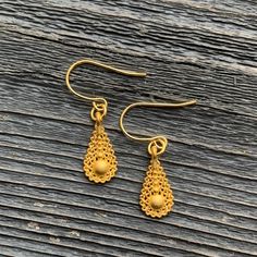 Ornate gold plated earrings with teardrop-shaped lattice design and central spherical bead. The earrings hang 1 1/4" long from gold plated ear wires. Gold Plated Filigree Teardrop Jewelry, Teardrop-shaped Gold Plated Filigree Jewelry, Gold Teardrop Pendant Earrings With Ear Wire, Gold Teardrop Pendant Earrings For Gift, Gold Hypoallergenic Teardrop Chandelier Earrings, Elegant Gold Pierced Drop Earrings, Gold Teardrop Pearl Drop Earrings, Yellow Gold Dangle Teardrop Earrings, Gold Teardrop Pearl Drop Earrings Gift